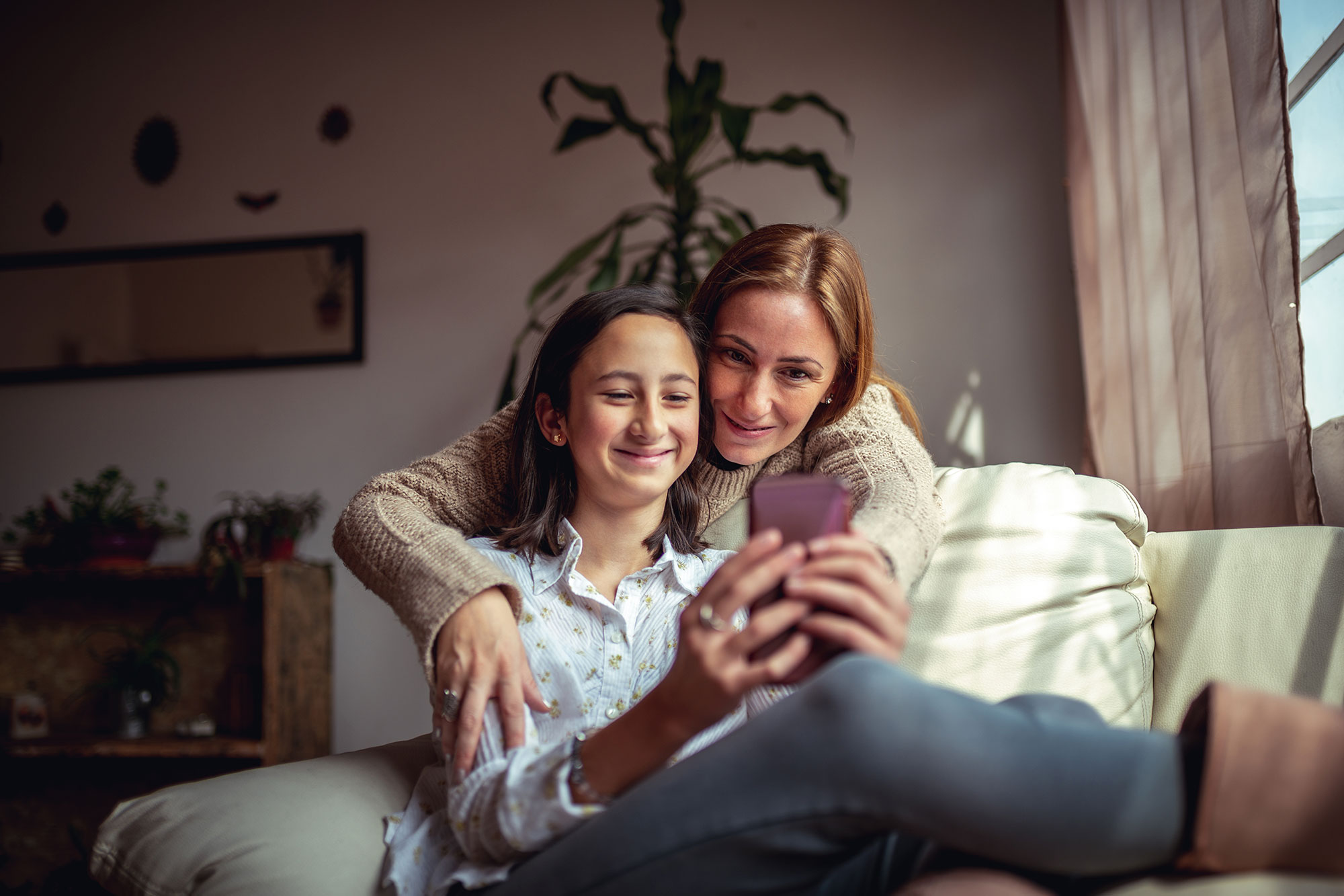 photo of a mother and daughter using a smartphone